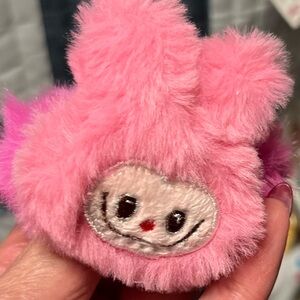 Plush Pink Small pair of hair ties or ponytails.